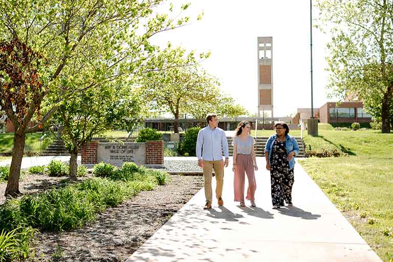 Three students walking out doors at Southwest Baptist University