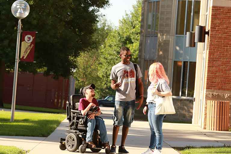 Three students talking. Photo courtesy of Northern State University
