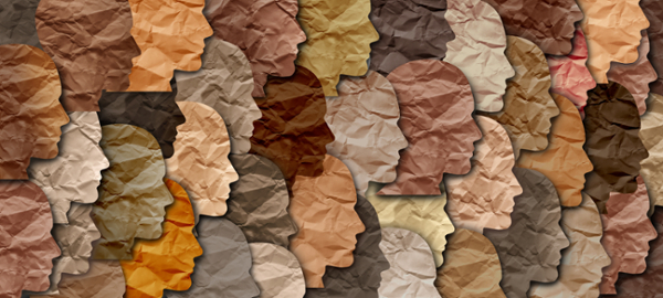 An art image of cultural diversity showing overlaying differently colored paper silhouettes.
