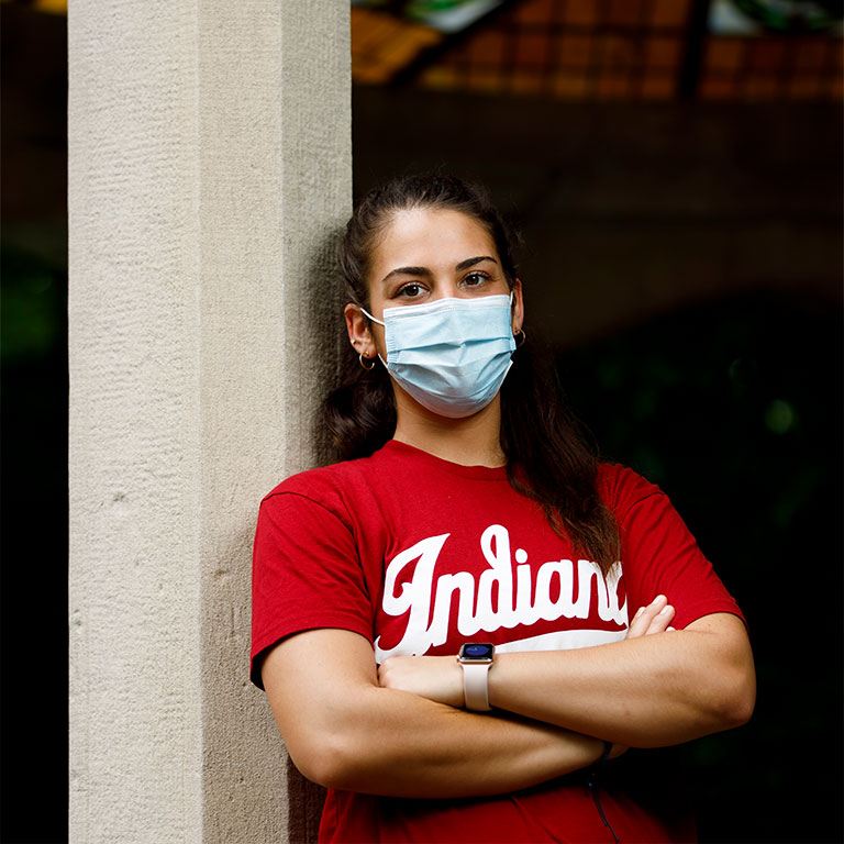 A student wearing an Indiana t-shirt and a protective mask